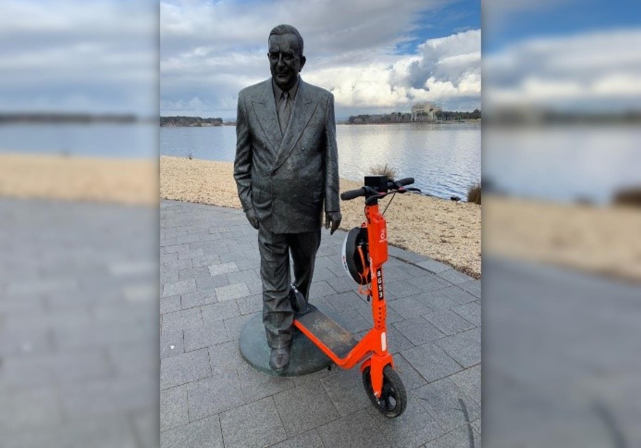 Statue positioned as if riding a scooter
